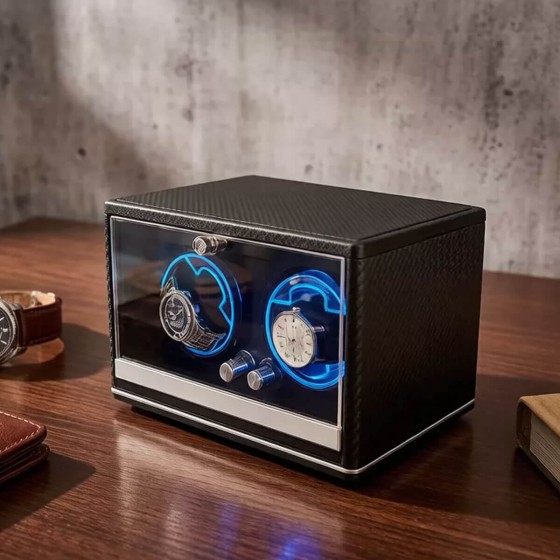 Roroos carbon fiber double watch winder on bedroom shelf — dual LED rings winding Rolex and Breitling automatic watches at night