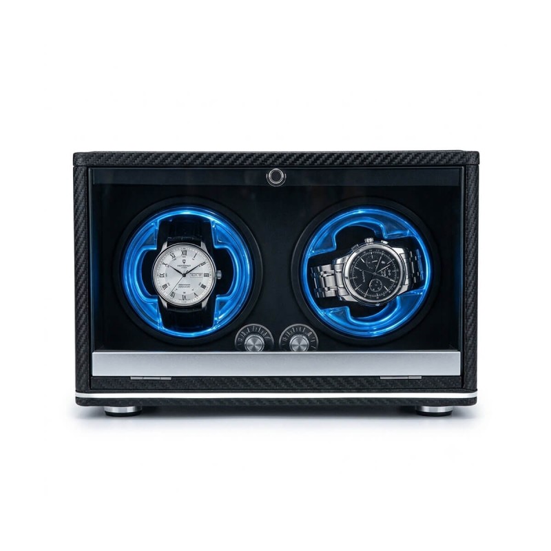 Carbon fiber double watch winder with dual LED ambient rings — lifestyle shot on dark wood desk with watches and accessories