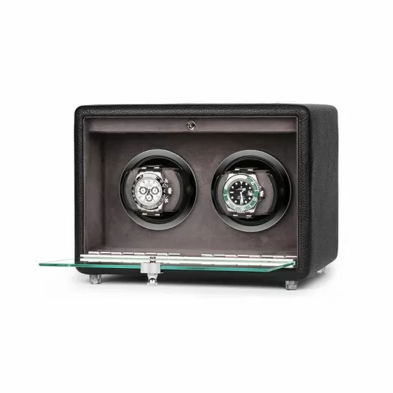 Doble relojero con tapa abierta mostrando dos almohadillas acolchadas para relojes y módulos de rotación