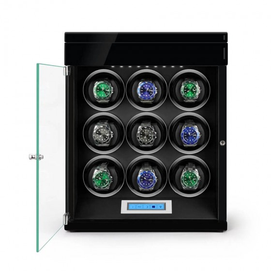 Open view of black automatic watch winder showing 4 rotating winding slots and extra storage below