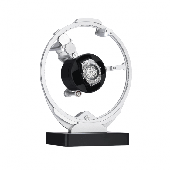 Side view of Roroos silver planetary gear winder with transparent acrylic dome over automatic watch