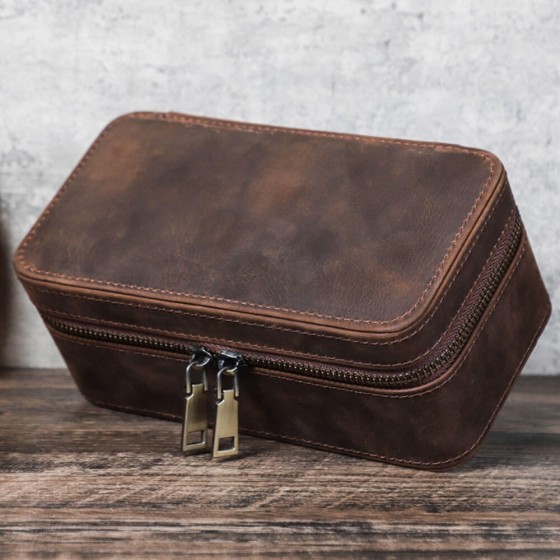 Closed Roroos brown leather travel jewellery box with secure strap closure — compact enough for carry-on luggage