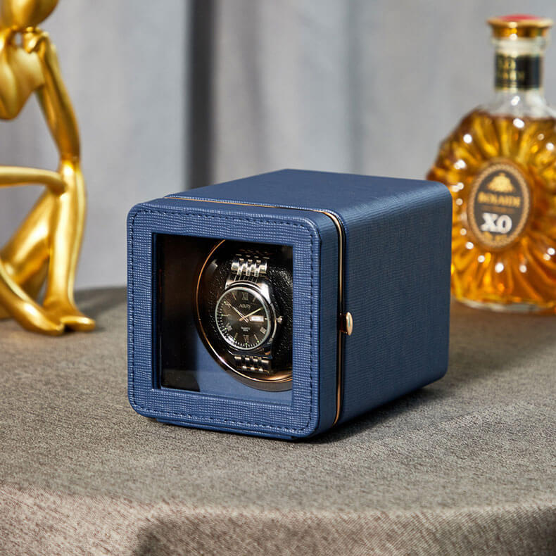 Close-up of a Phantom Blue leather single automatic watch winder box with a luxury mechanical watch inside a clear display window