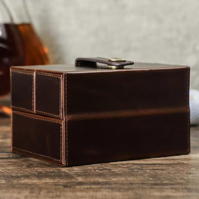 Compact 2-watch leather travel case next to luggage — portable size comparison